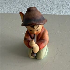 Charming Figurine with Brown Hat and Orange Jacket